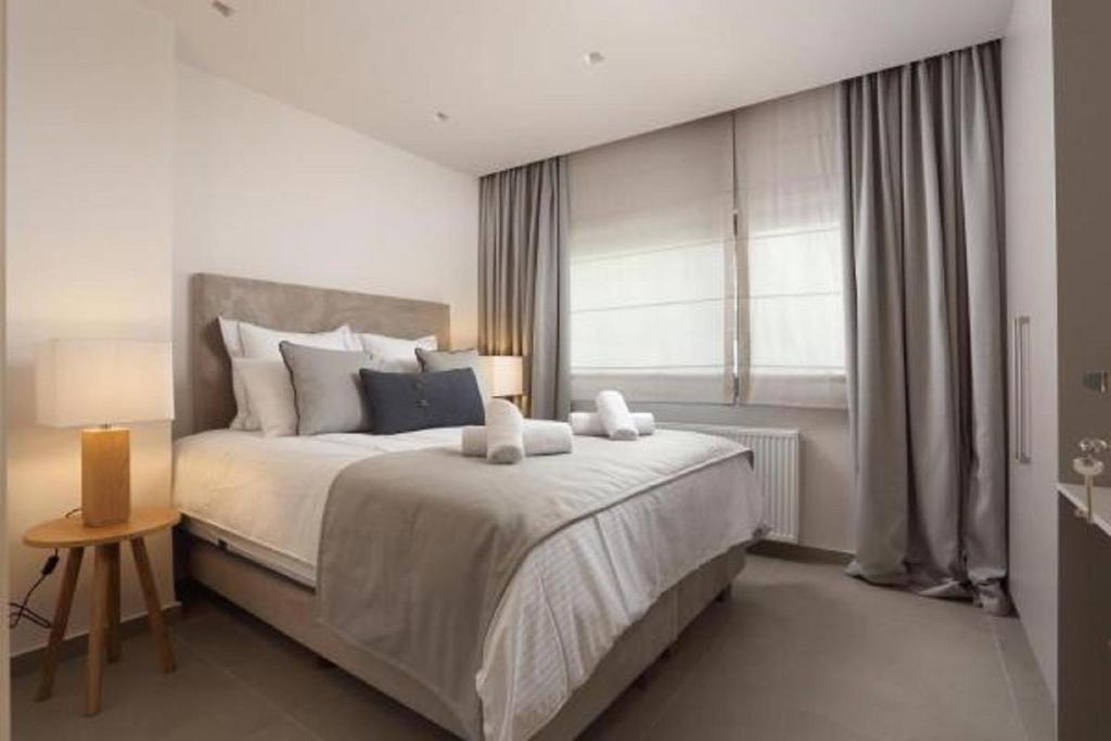 a bedroom with a large bed and a window at Hector Luxury Suite in Athens