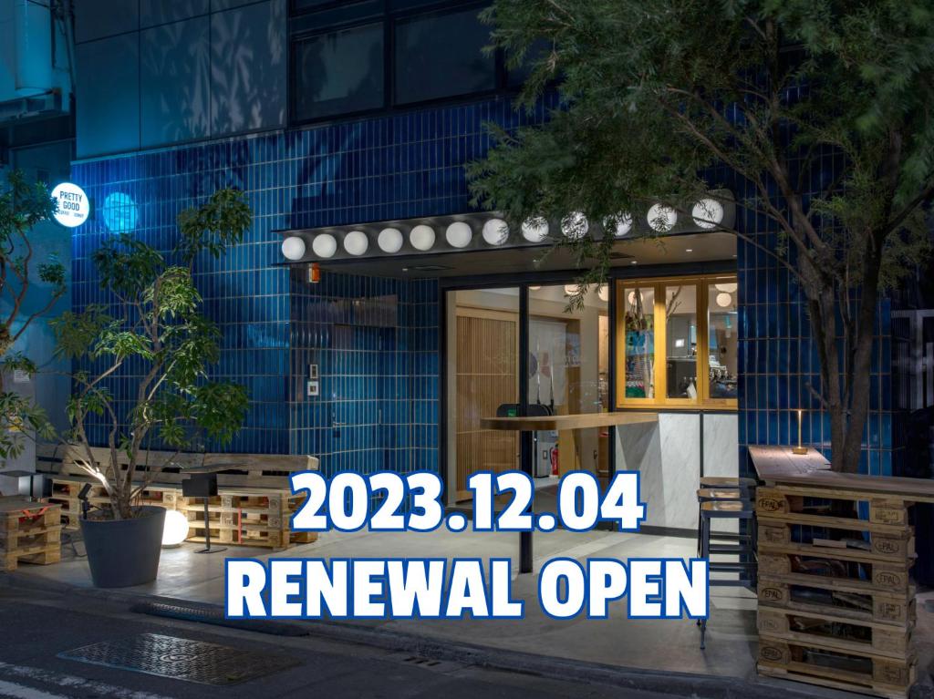a renewal open sign in front of a building at CAFE/MINIMAL HOTEL OUR OUR in Tokyo