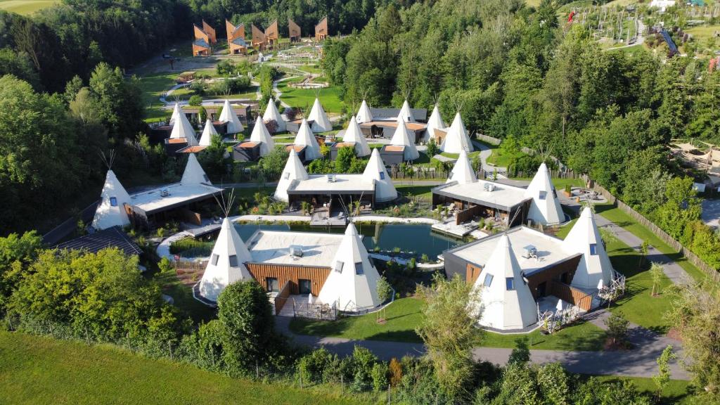 an aerial view of a large house with white roofs at IKUNA Naturresort in Natternbach