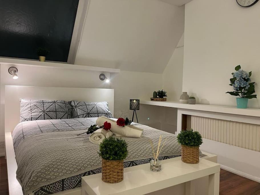 a bedroom with a bed with two plants on it at Modern cosy studio in Barbican - Green - F2 in London