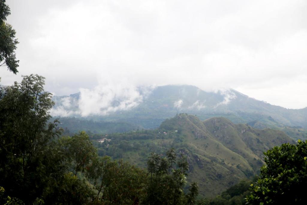 a view of a mountain with clouds on it at The Dream Inn in Ella