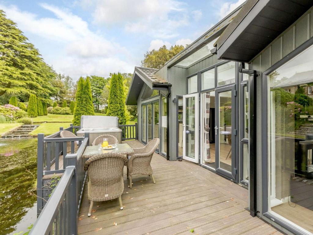 a patio with a table and chairs on a deck at 2 Bed in Ilfracombe 87361 in Kentisbury