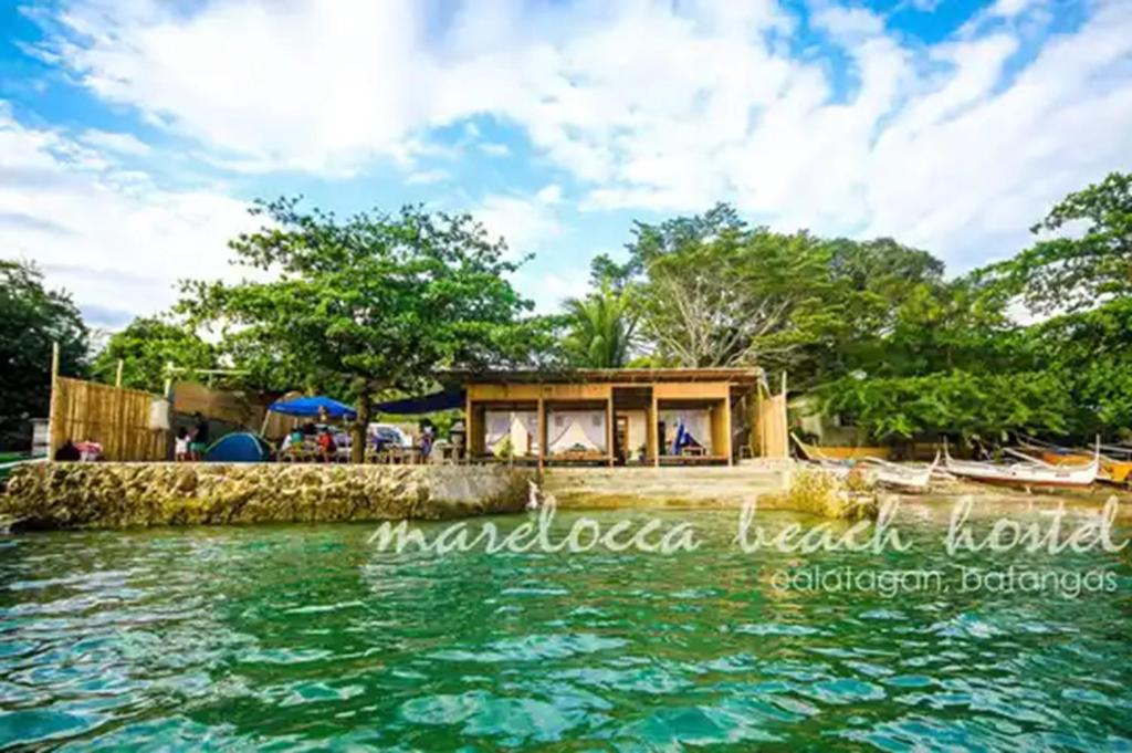 a house on the shore of the water at Marelocca Beach House in Calatagan