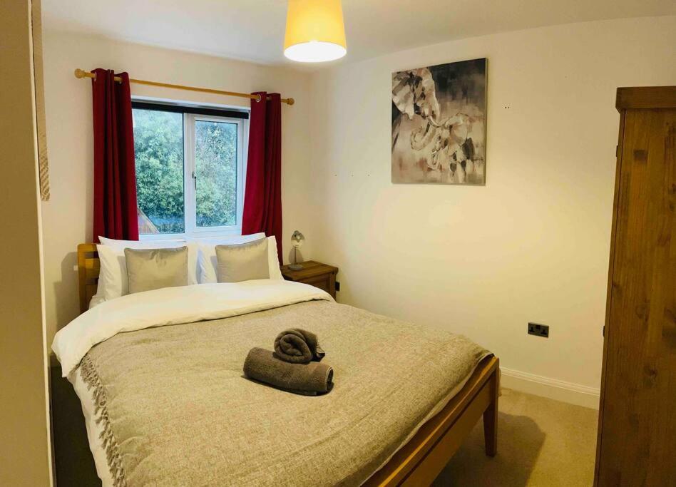 a bedroom with a bed with a hat on it at Balcony views + Parking in Lincolnshire