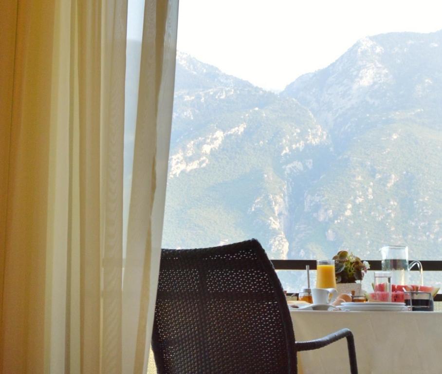 a table and a chair in front of a window at Alexakis Hotel & Spa in Loutra Ipatis