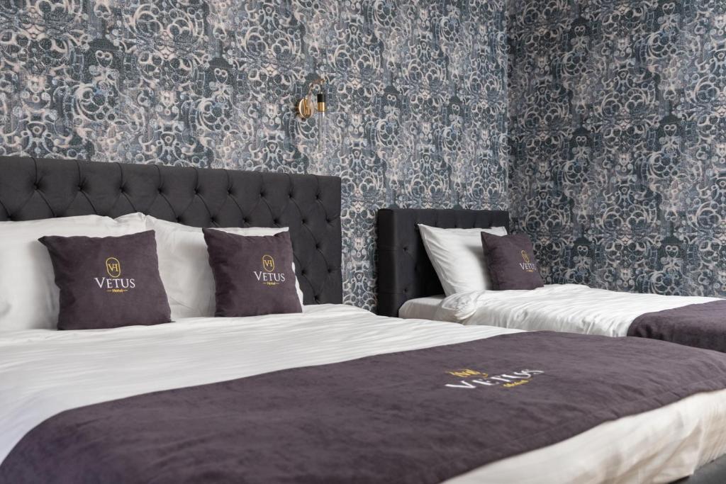 Postel nebo postele na pokoji v ubytování Vetus Hotel