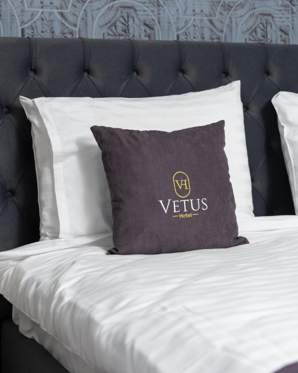 Postel nebo postele na pokoji v ubytování Vetus Hotel