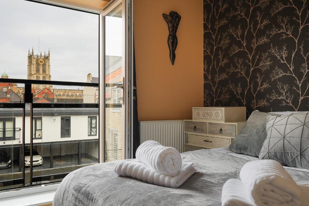 a bedroom with a bed and a large window at Modern home in the Hull Marina in Hull