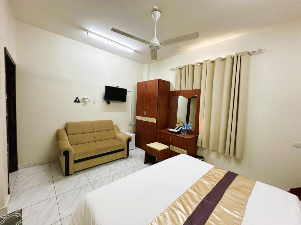 Postel nebo postele na pokoji v ubytování Bahla Jewel Hotel Apartments