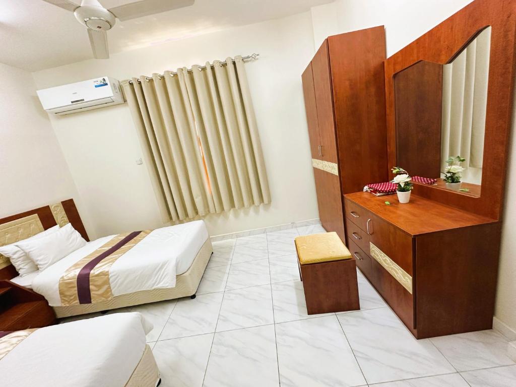 Postel nebo postele na pokoji v ubytování Bahla Jewel Hotel Apartments