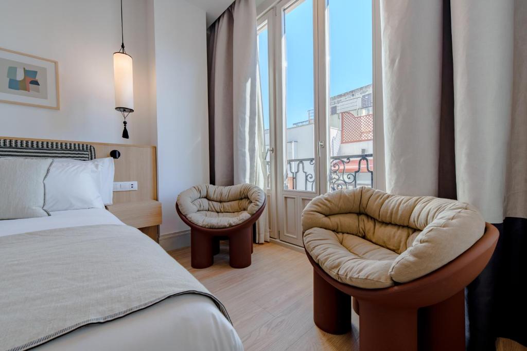 Postel nebo postele na pokoji v ubytování Apartamentos Soho Boutique Hoy No Me Puedo Levantar