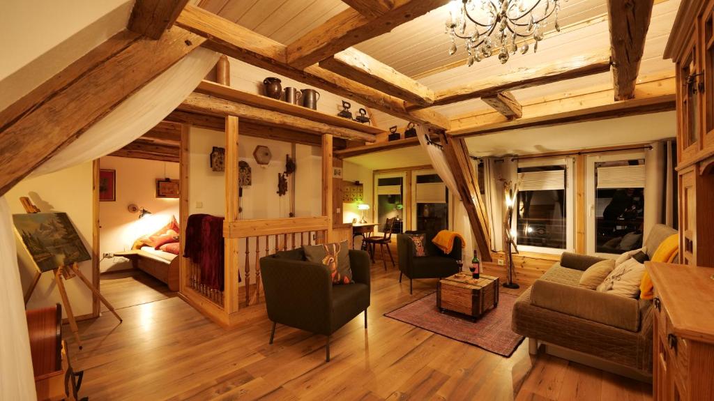 a large living room with wooden ceilings and furniture at Rosi´s Häusle Schwarzwald / Terasse mit Garten in Winzeln