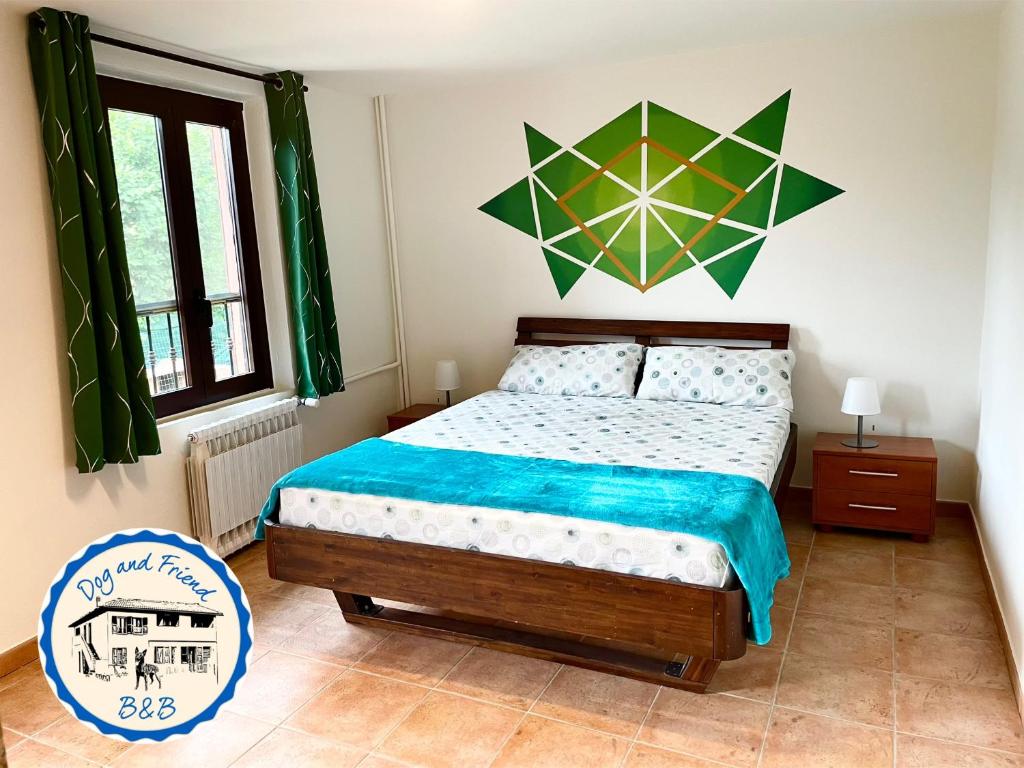 a bedroom with a bed with a blue comforter at BnB Dog and Friend in Rocchetta Tanaro