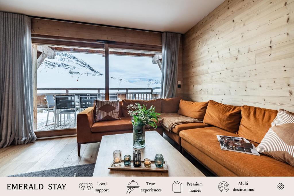 a living room with a couch and a table at Apartment Wapa Alpe d'Huez - by EMERALD STAY in L'Alpe-d'Huez