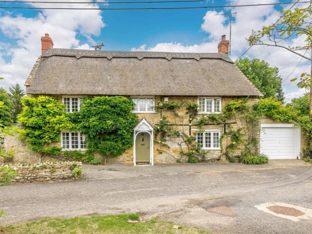 an old stone house with a garage at 3 Bed in Beaminster 87914 in South Perrott
