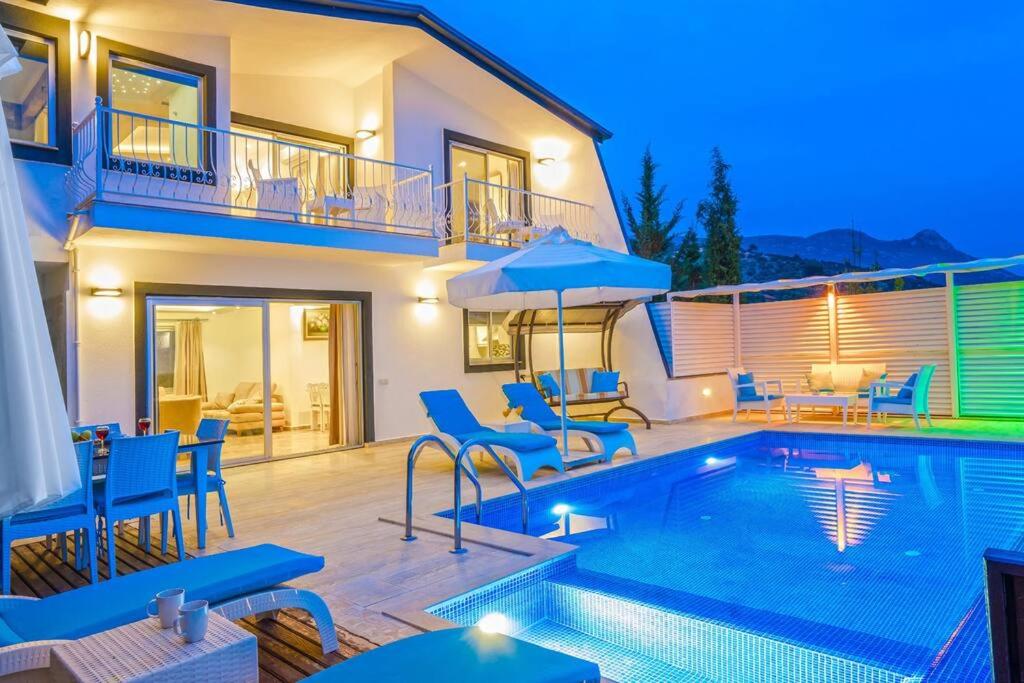 a villa with a swimming pool and a house at Villa Mono / Kalkan in Kas