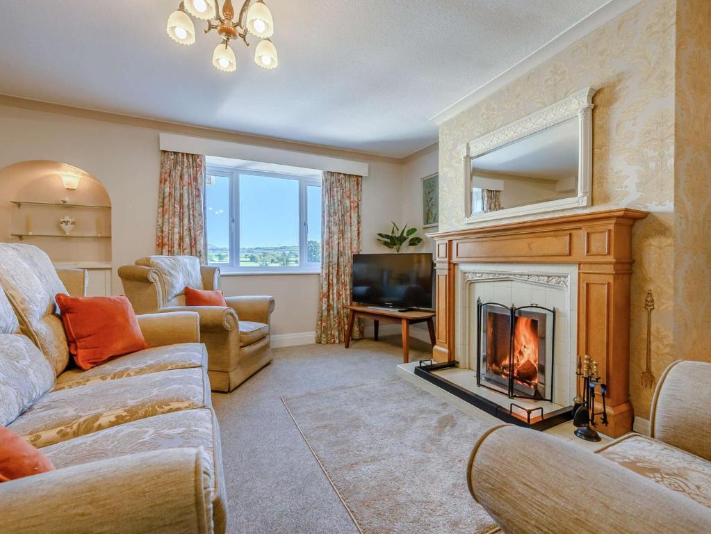 a living room with a fireplace and a television at 3 Bed in Cockermouth 89139 in Aspatria