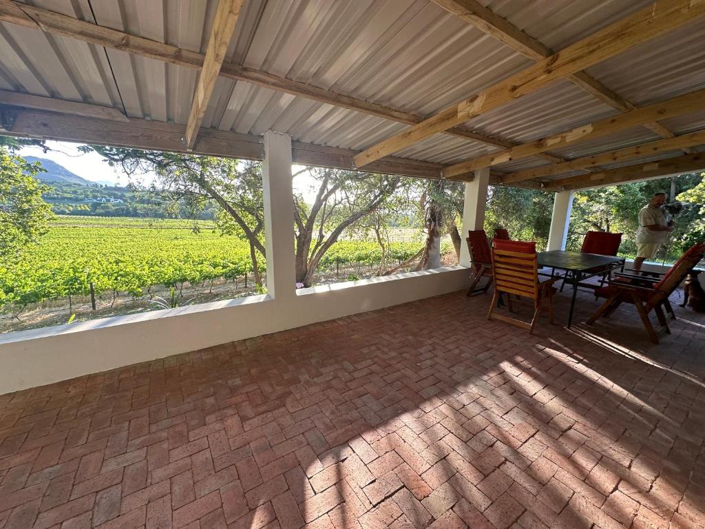 a patio with a table and chairs and a view at Florie se Huis in Paarl