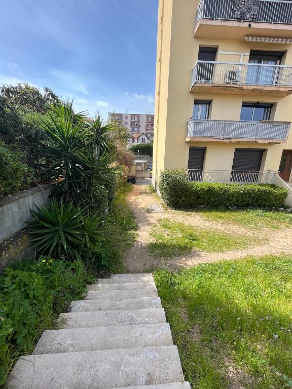 un chemin en face d'un immeuble d'appartements dans l'établissement Superbe T2 avec place de parking, à Ajaccio