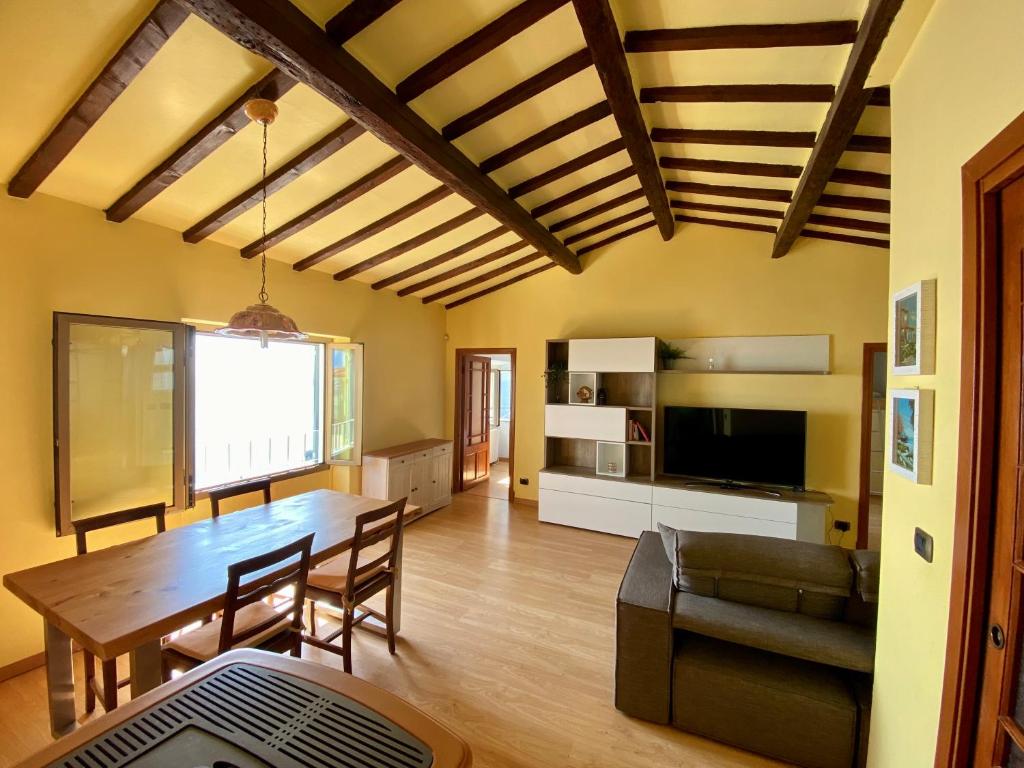 a living room with a wooden table and a couch at Kiss of sea - Balzi Rossi & Baia Beniamin in Ventimiglia