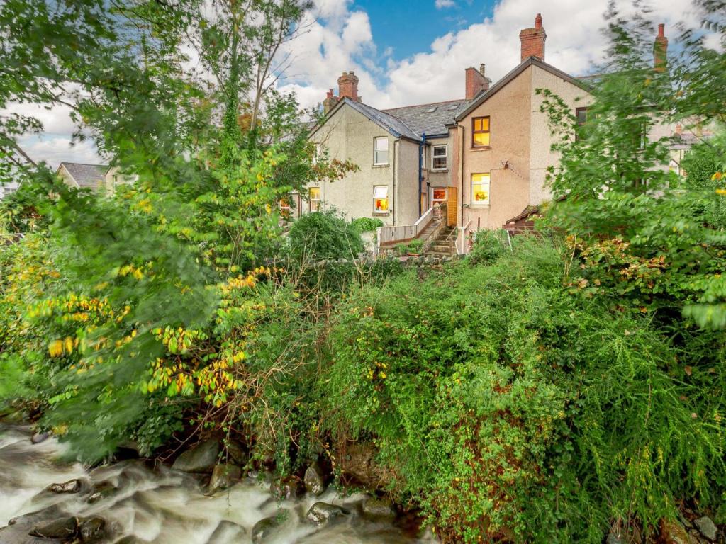 a house in the middle of a river with trees at 3 Bed in Llanfairfechan 89646 in Llanfairfechan