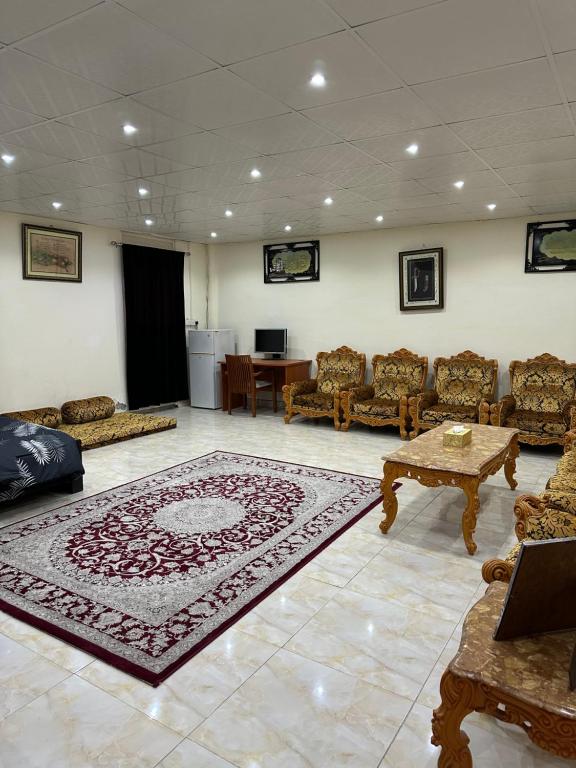 a living room with a rug on the floor at Al Ramla, Na’eem Bin Masoud St#8, Villa#10 in Sharjah