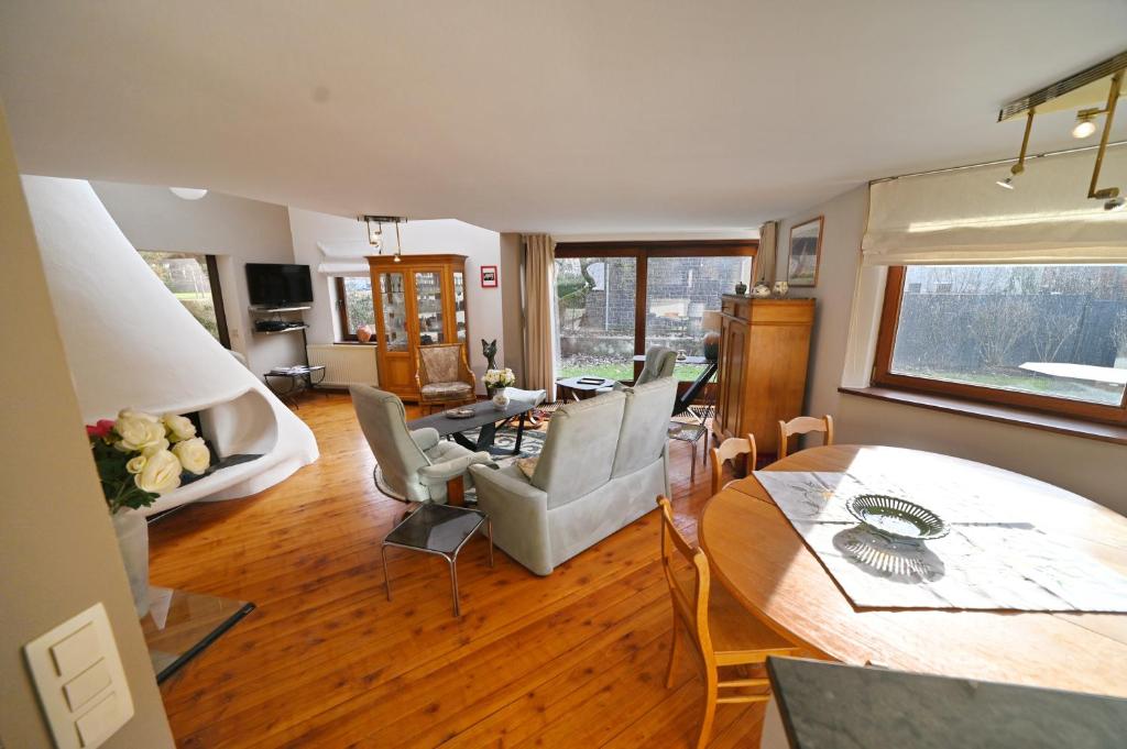 a living room with a couch and a table at Symon Lodge in La Roche-en-Ardenne
