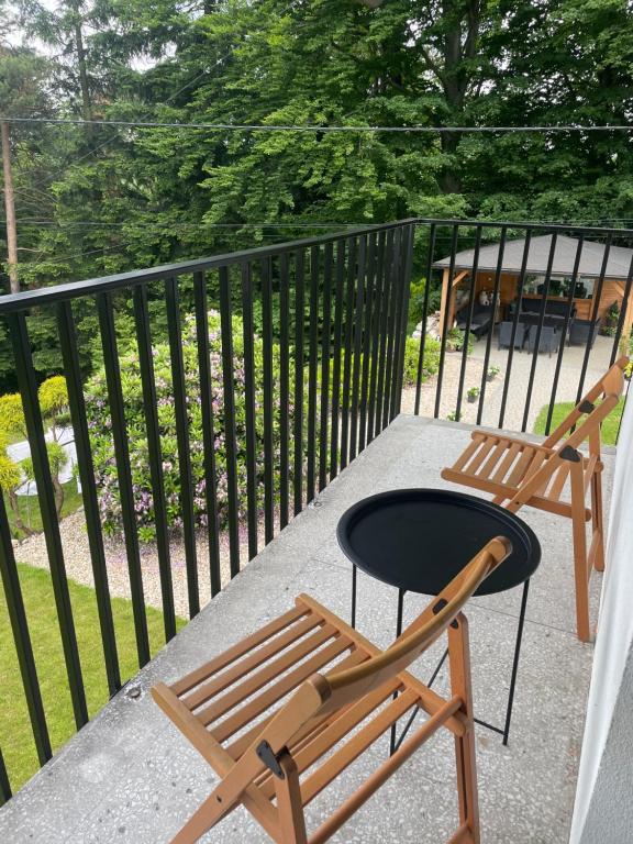 a chair and a table on a balcony at Villa Vincentów in Myślenice