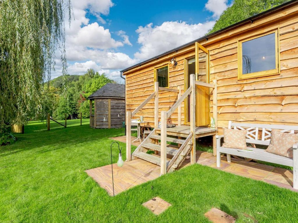 a log cabin with a staircase next to a yard at 1 Bed in Newchurch 89932 in Newchurch