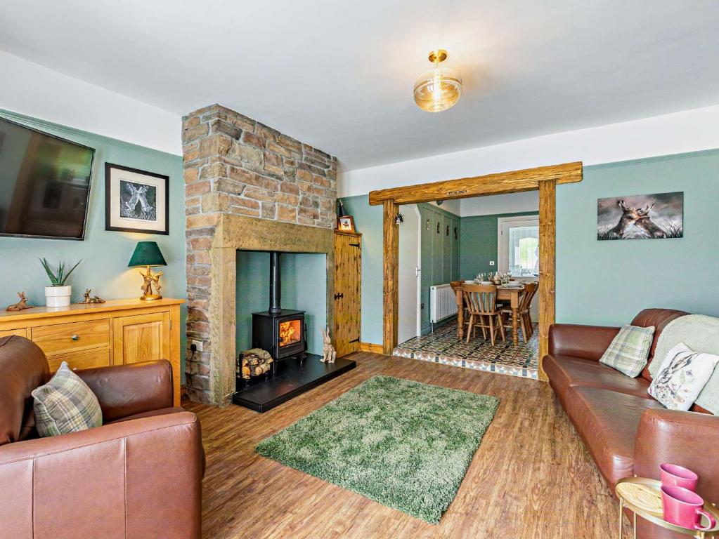 a living room with a couch and a fireplace at 3 Bed in Hamsterley 89896 in Witton le Wear