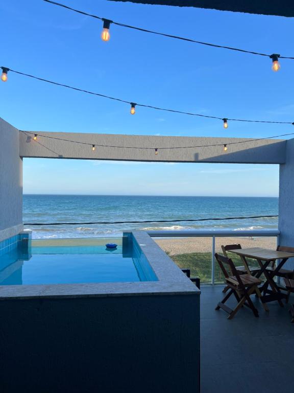 a view of the ocean from the balcony of a house at Triplex Vista Azul in Rio das Ostras