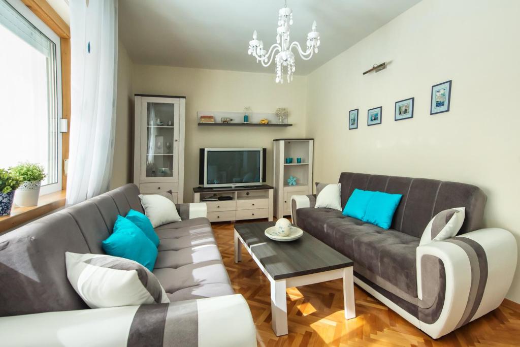 a living room with a couch and a tv at Apartment Carmela in Split