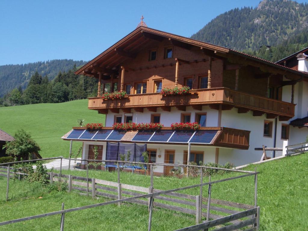 a house on a hill with solar panels on it at Leirerfeld in Alpbach