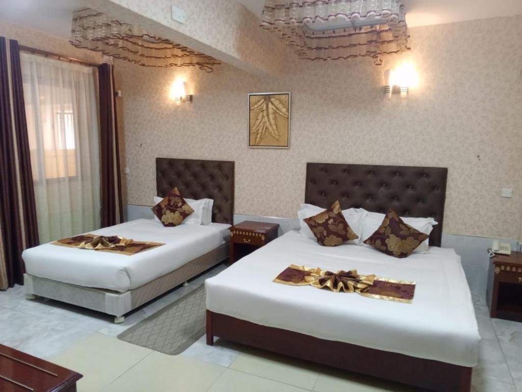 Postel nebo postele na pokoji v ubytování Easy Hotel Kenya