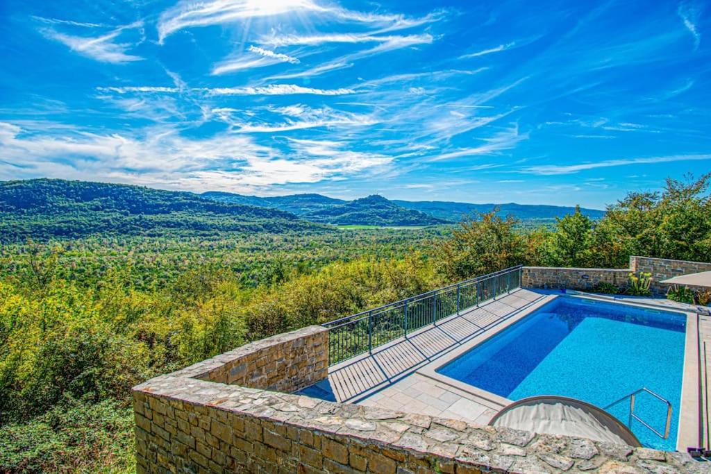 a swimming pool with a view of the mountains at Villa Banic Motovun,Istrien in Motovun