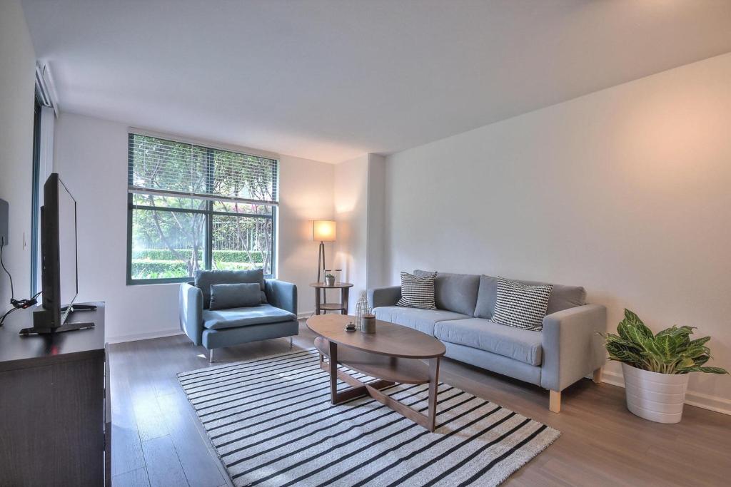 a living room with a couch and a table at South Beach 1br w heated pool nr att park SFO-1657 in San Francisco