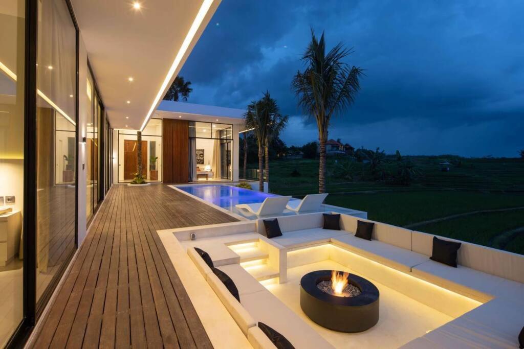 a house with a fire pit on a deck at NEW Luxury 3BR, Jacuzzi Rooftop Rice Field, Staff in Legian
