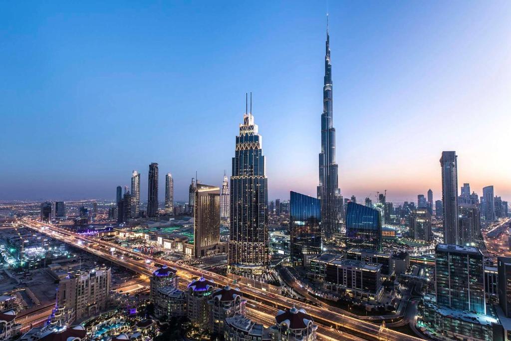 a view of a city skyline at night at Kempinski The Boulevard Dubai in Dubai