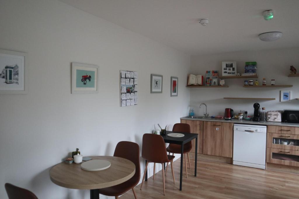 a kitchen with a table and chairs and a kitchen with a counter at Cedar Lodge in Killarney