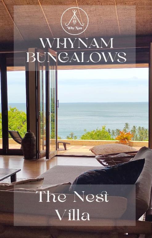 a living room with a view of the ocean at Why Nam Beach in Haad Yuan