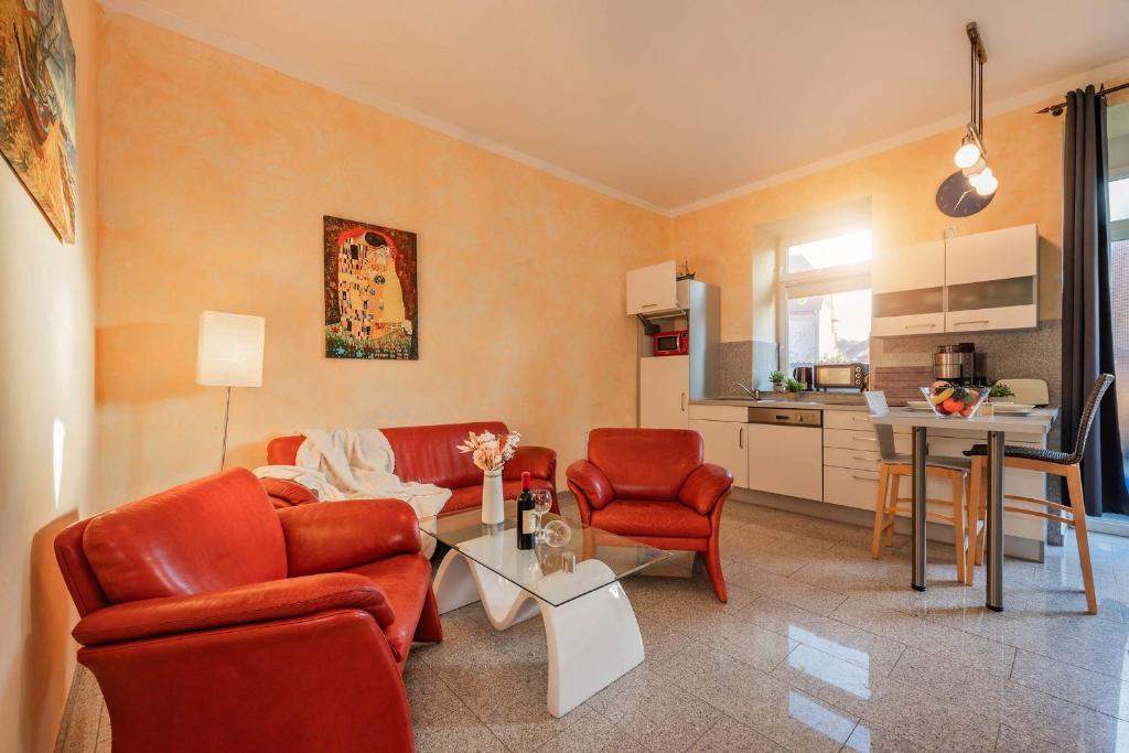 a living room with a couch and chairs and a table at Der Schlosshof - 02 in Pudagla