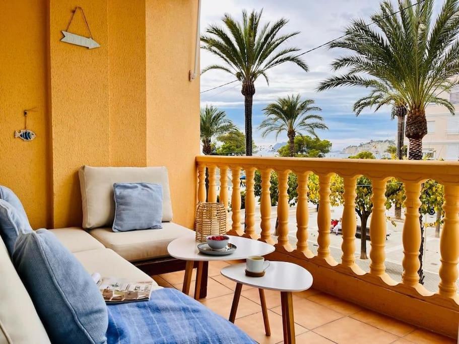 a living room with a balcony with palm trees at Luxe appartement op 50 meter van zee in Moraira in Moraira