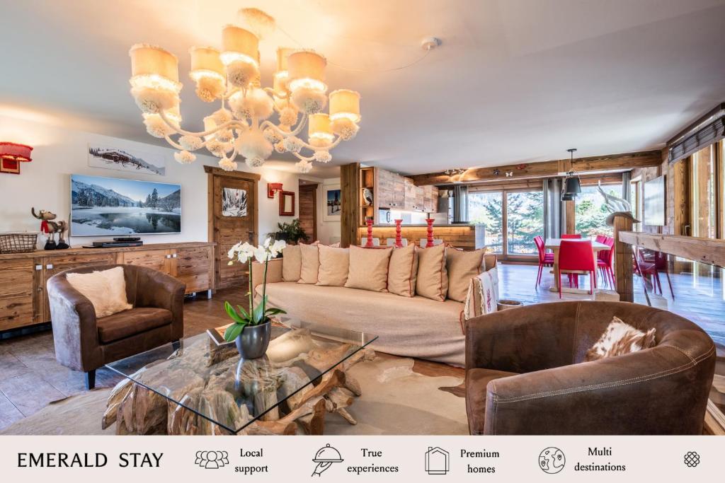 a living room with a couch and chairs and a chandelier at Apartment Moabi Le Praz Courchevel - by EMERALD STAY in Courchevel