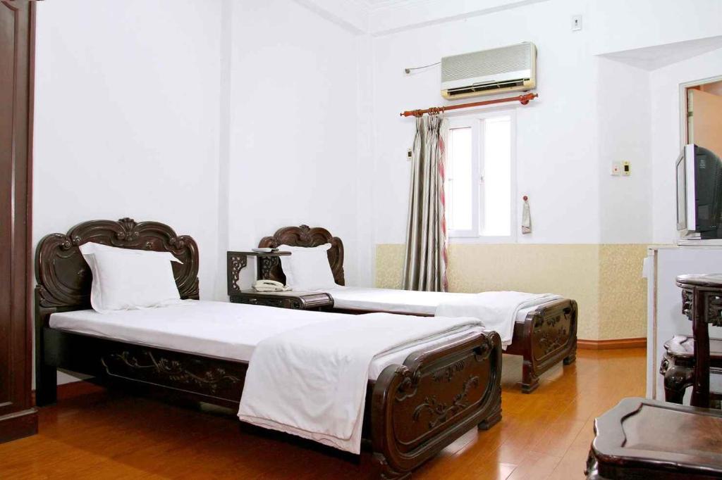 Postel nebo postele na pokoji v ubytování HOÀNG CƯỜNG HOTEL 15 Nguyễn Thái Học