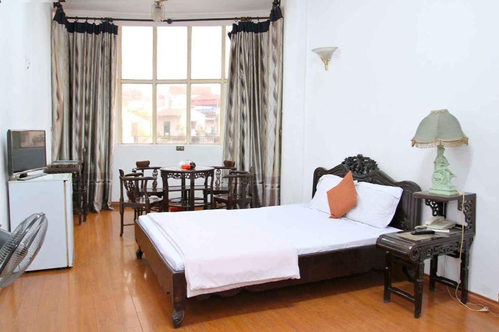 Postel nebo postele na pokoji v ubytování HOÀNG CƯỜNG HOTEL 15 Nguyễn Thái Học