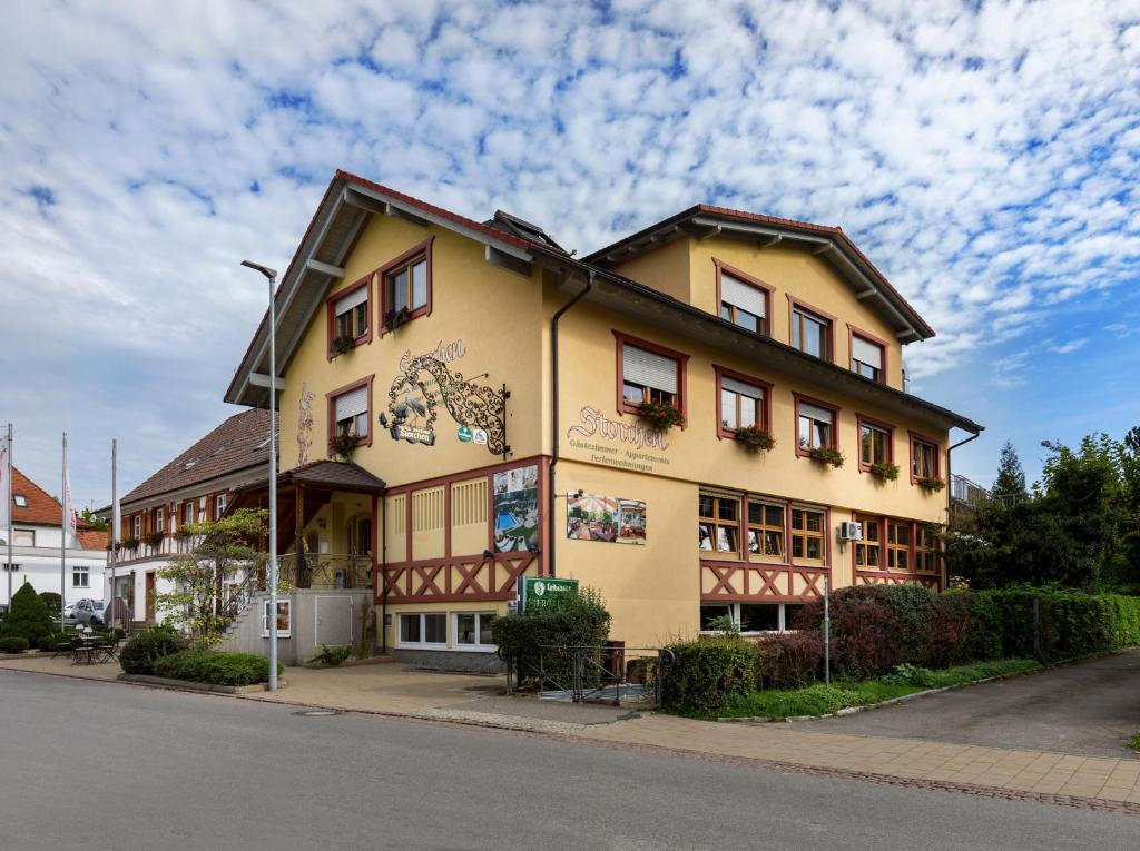 a yellow building on the side of a street at Bodensee Hotel Storchen in Uhldingen-Mühlhofen