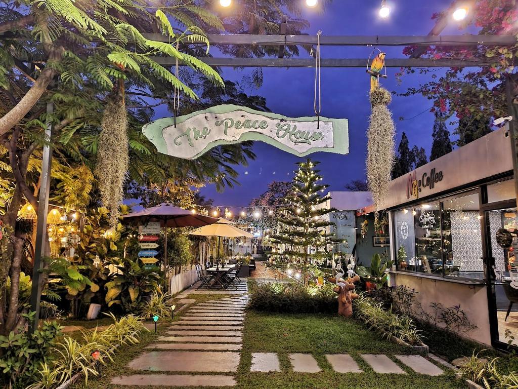 a christmas market with a christmas tree and a sign at The Peace House - Siem Reap in Phumĭ Sândăn