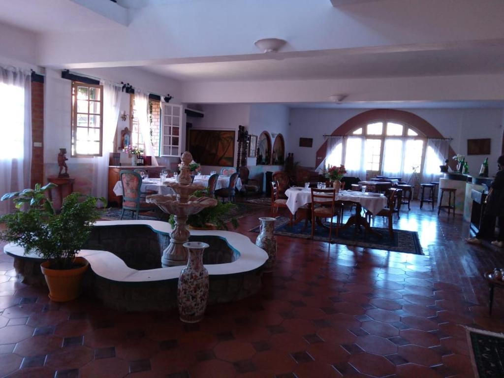 a living room with tables and vases on the floor at Le Castel des Seigneurs in Antananarivo