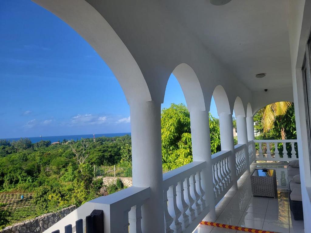 a balcony with a view of the ocean at Zuri Enterprise in Negril