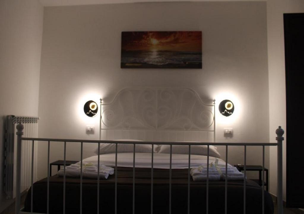 a bedroom with a bed with two lights on it at Casa nel Centro di Avellino in Avellino